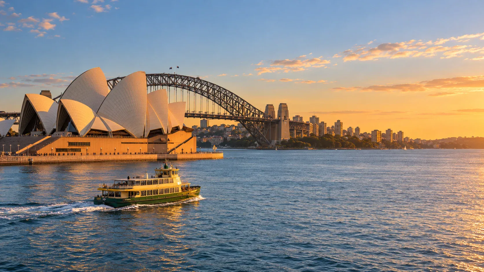 Sydney Opera House and Harbour Bridge at golden hour with a ferry crossing calm harbour water